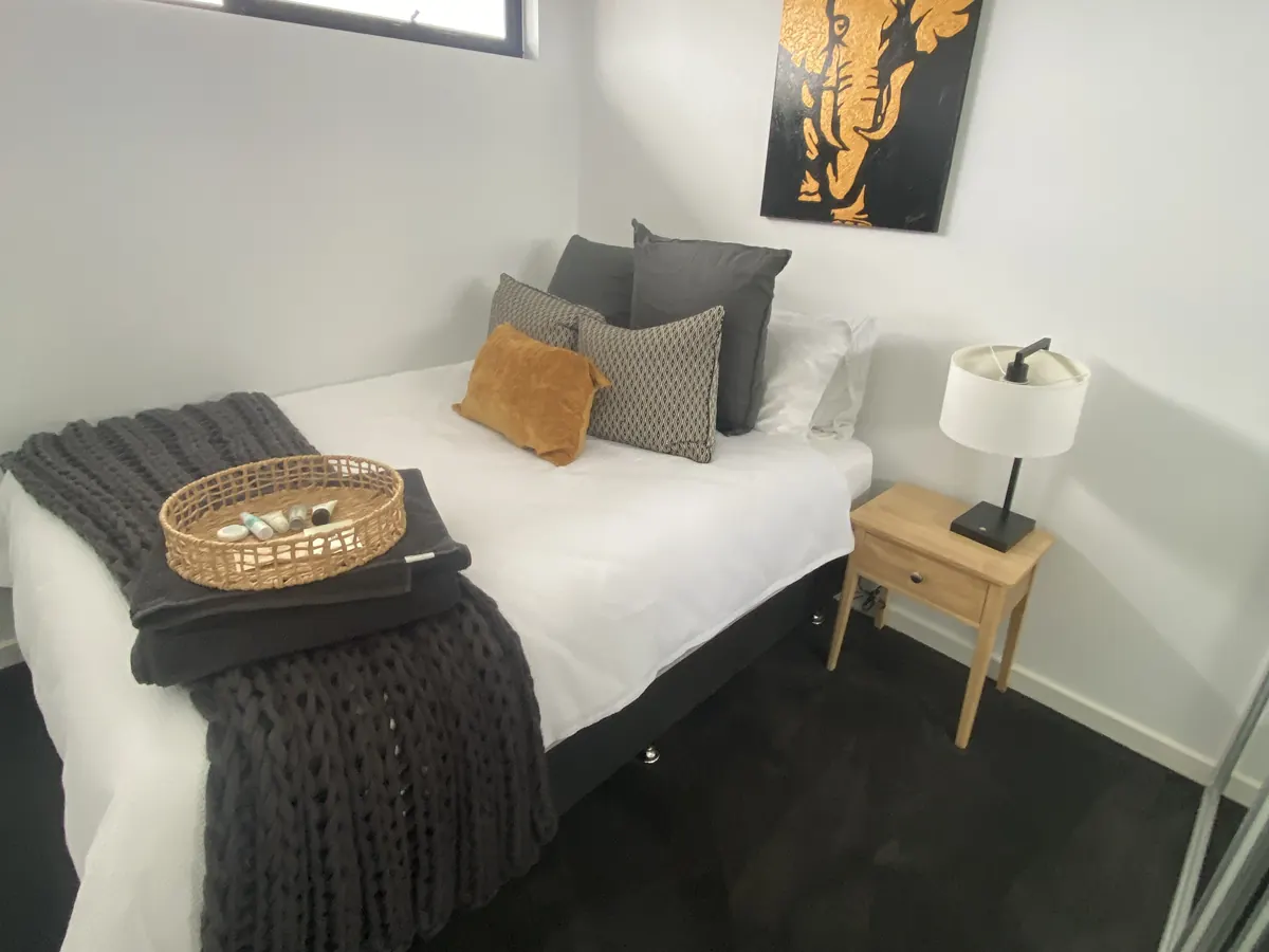 Freshly cleaned bedroom with a made bed