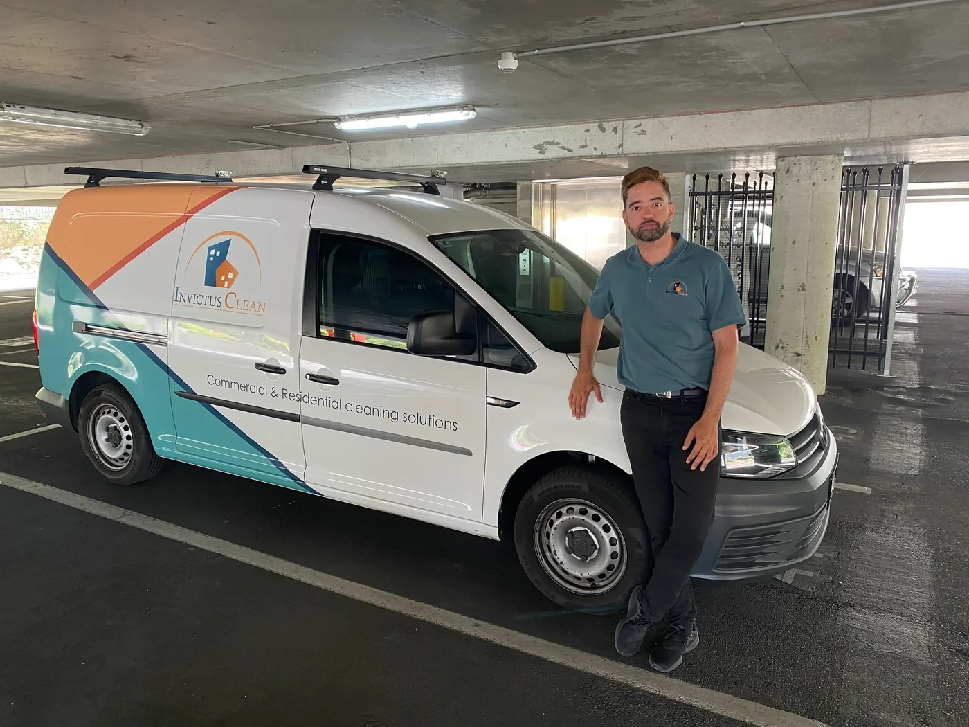 Invictus Clean team leader beside branded cleaning van in Adelaide